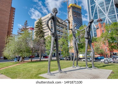 Calgary, Canada - June 29, 2018: Public Art Resembling Early People Of The Canadian Landscape Stand Majestically In Downtown Calgary, Canada