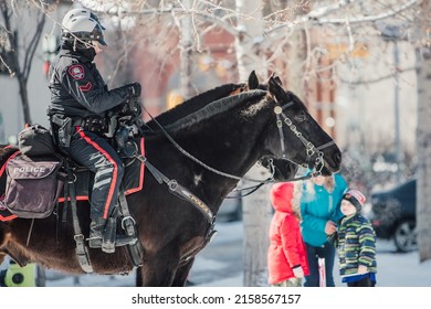 CALGARY, CANADA - Mar 06, 2022: Two Police Officers Seated Atop Horseback At A Local Peaceful Protest