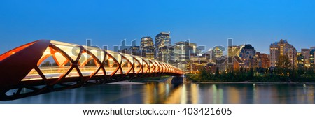 Calgary cityscape with Peace Bridge and downtown skyscrapers in Alberta at night, Canada.