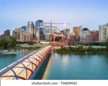 Calgary downtown with iluminated Peace Bridge and full moon, Alberta, Canada
