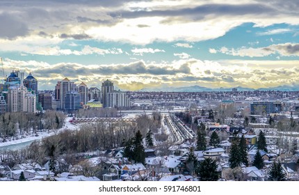 Calgary downtown and river winter view with mountains in background 
