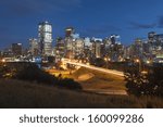 Calgary Skyline at night with centre street bridge and bow river.