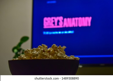 Cali, Colombia - August 26, 2019: Netflix App On Tv Screen Playing The Grey's Anatomy Serie Behind A Bowl Of Popcorns.