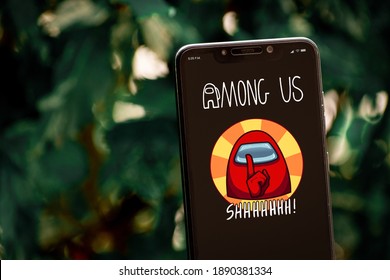 Cali, Colombia - January 9, 2020: Smartphone with "Among Us" mobile game logo on screen.