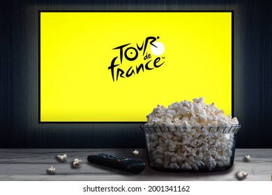 Cali, Colombia - July 2, 2021: The Tour De France Logo On Tv Screen Behind A Bowl Of Popcorn And A Remote Control.