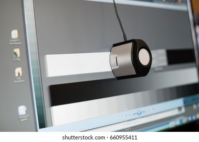 calibrating the display of a computer with a special device, close-up