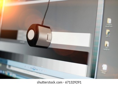 calibrating the display of a computer with a special device at sunset, close-up