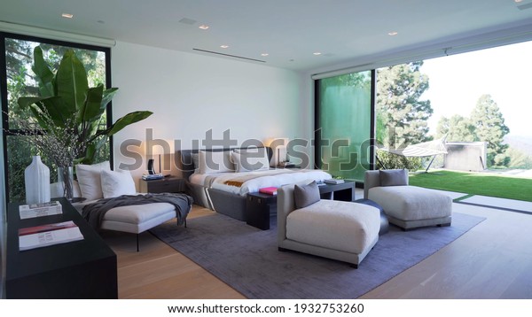 California, 10 March 2021: Luxurious Bright
Bedroom With Comfortable King Size Bed and Modern Furniture.
Template For Expensive Residential Mansion. Concept For Interior,
Architecture And
Lifestyle.