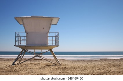 California beach with life guard tower on bright blue day with no people