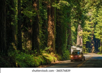 California Camper Journey. Small SUV With Compact Travel Trailer On The Redwood Highway In Northern California, USA.