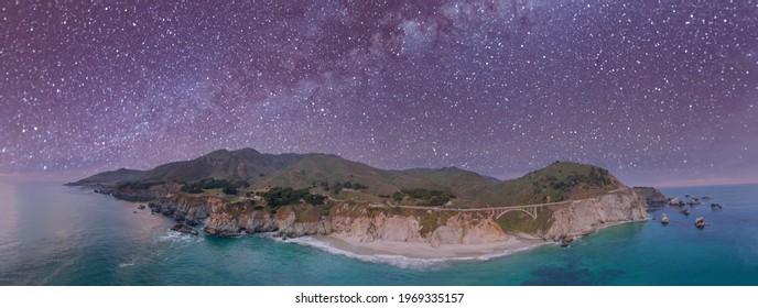 California Coastline Panoramic View From Drone. Bixby Bridge Along The Big Sur On A Starry Night, USA.