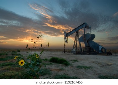 California Crude Oil Wells, Energy, And Fossil Fuel Industry, With Background Of Setting Sun.