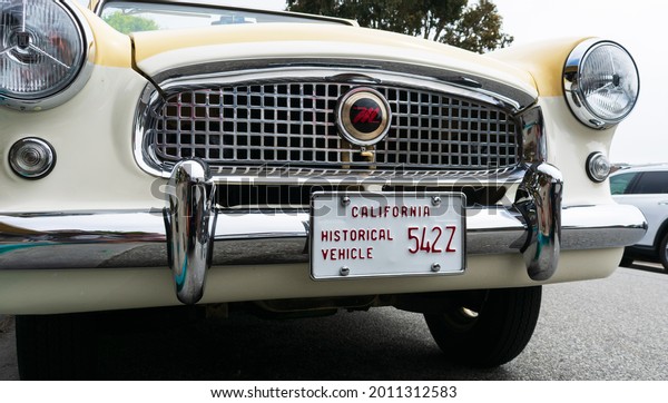 California Historical\
Vehicle license plate on front chrome bumper of Nash Metropolitan\
vehicle of historic value and interest. Close up - Carmel,\
California, USA -\
2021