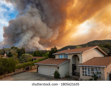 The California "River Fire" of Salinas,  in Monterey County, was ignited by dry lightning on August 16, 2020, fills the sky with dark smoke and flames as it burns close to a houses on its first day.  