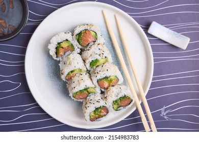 California Roll With Avocado And Salmon In The Table With Chopsticks