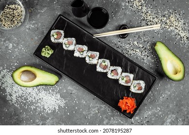 California Roll Sushi Traditional Japanese Rice Food With Salmon, Avocado, Cucumber, Nori And Sesame Seeds.