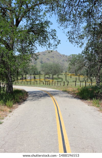 California rural road in countryside landscape of\
Tulare County.