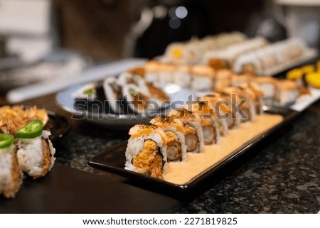 California sushi roll topped wit salmon. Japanese traditional dishes. selective focus  Stockfoto © 