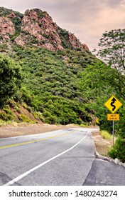 California Two Lane Highway With Traffic Sign Indicating Winding Road Ahead.