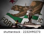 California US state flag with statue of lady justice, constitution and judge hammer on black drapery. Concept of judgement and punishment