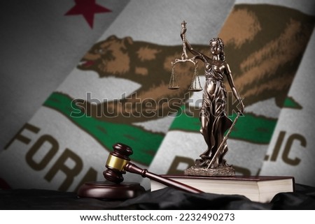 California US state flag with statue of lady justice, constitution and judge hammer on black drapery. Concept of judgement and punishment