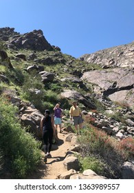 CALIFORNIA, USA - MARCH 24, 2019: People Hike In Tahquitz Canyon, Located In Southern California In The Coachella Valley Near Palm Springs, California. It Is A Bright Sunny Day With Clear Blue Sky.