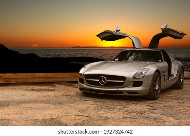 California, year 2017: Front view of a silver Mercedes-Benz SLS AMG. Sunset and the beach in background. German supercar.