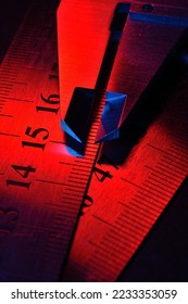caliper and metal rulers illuminated in red and blue. close-up - Shutterstock ID 2233353059