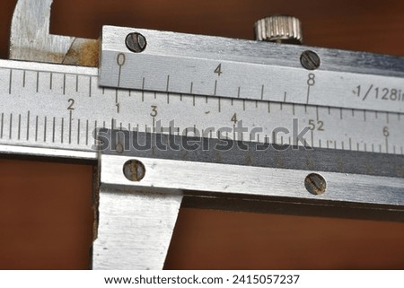 Caliper for precision measuring graduated in fractional inches and millimeters