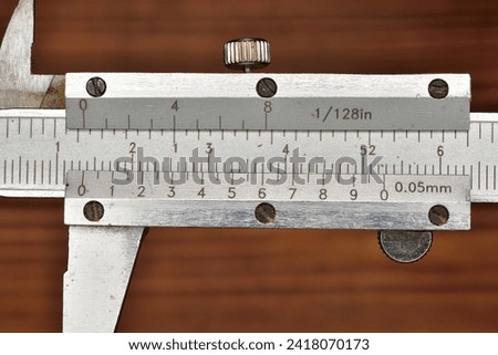 Caliper for precision measuring graduated in fractional inches and millimeters