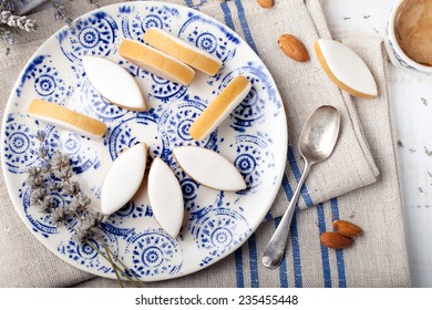 Calissons d'Aix-en-Provence on a ceramic plate on a white wooden background. Traditional French Provence sweets.