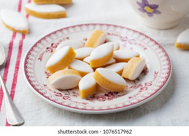 Calissons traditional French Provence sweets on a plate. Tablecloth background. Close up.