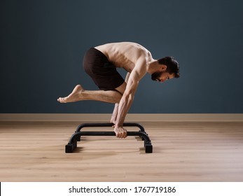 A Calisthenics Instructor Trains Alone At Home For A Perfect Performance With Push Up Bars