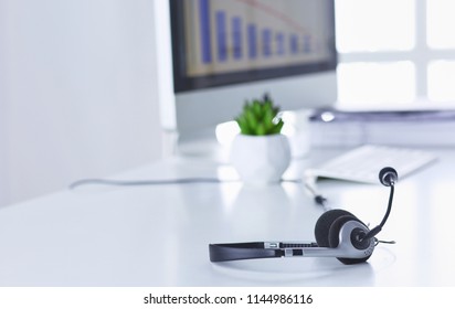 Call center and customer service help desk. VOIP headset on laptop computer keyboard - Shutterstock ID 1144986116
