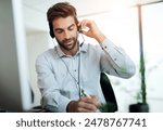 Call center, customer service and man writing notes in office for online consultation appointment. Contact us, crm and male technical support or telemarketing agent with schedule for feedback.