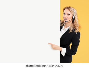 Call Center. Customer Support Service Female Phone Operator Or Sales Agent In Headset, Confident Suit Standing Behind Signboard With Copy Space Area For Text, Isolated On Yellow Background