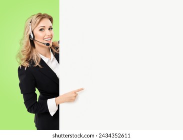 Call center. Customer support service phone operator, sales agent in headset, stand behind peep from signboard banner billboard board point show copy space ad text area, isolated green wall background - Powered by Shutterstock