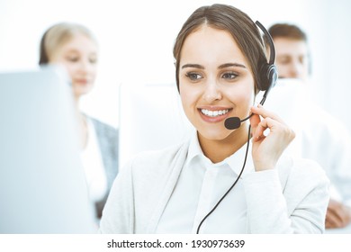 Call Center. Group Of Diverse Operators At Work. Beautiful Woman In Headset Communicating With Customers Of Telemarketing Service. Business Concept