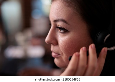 Call center operator helping clients on telemarketing helpline, working at customer care service to give support and assistance. Female sales consultant using remote telecommunication. Close up.