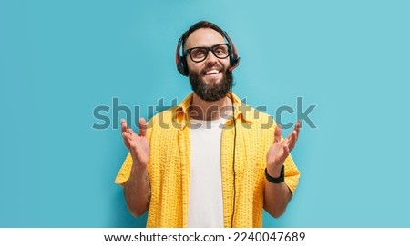 Call center operator, online store service manager wears headphones speaks into microphone answers call, leads negotiations advises online sales. Isolated on blue background