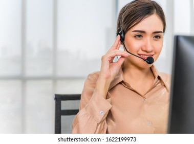 Call Center Operators. Beautiful Asian Woman Working Service Consulting Clients With Headset And Computer In Workplace Service Center.