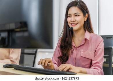 Call Center Operators. Beautiful Asian Woman Working Service Consulting Clients With Headset And Computer In Workplace Service Center.