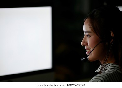 Call Center Service Agent With Headset Working Support Hotline In Modern Office With Screen Laptop Copy Space. Portrait Beautiful Positive Women Conversation With Customer From Phone In Night Shift.