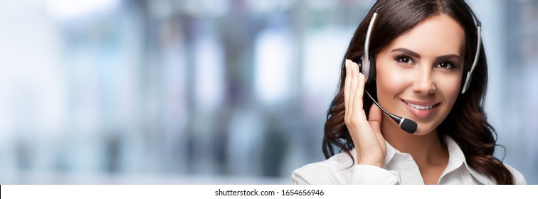 Call Center Service. Customer support or sales agent, over blured office background. Female caller or receptionist phone operator. Copy space for some text. Help, answering and telemarketing.
