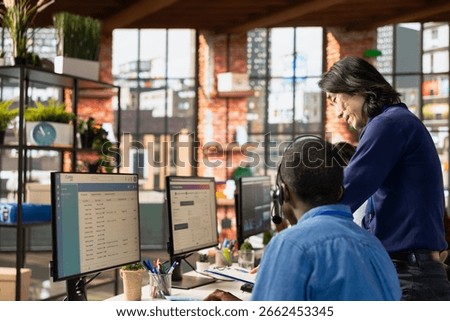 Call center supervisor checking progress done by agents investigating lost clients packages in office. Customer support manager supervising staff members using program on PC to locate clients parcels