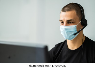 Call Center Telephone Operator In Office Wearing Face Mask