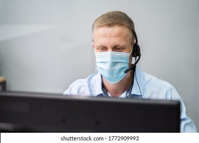 Call Center Telephone Operator In Office Wearing Face Mask