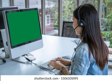 Call Center Woman Sitting In Customer Service Office In Front Of The Computer, Green Screen With Clipping Path