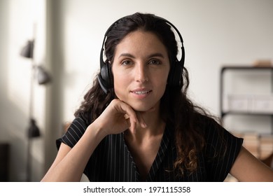Call center worker. Headshot portrait of pleasant millennial hispanic woman in wireless headphone set customer support manager telemarketer. Young female hotline service desk operator look at camera