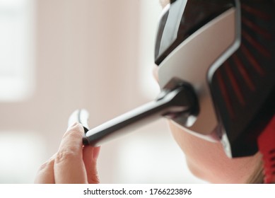 A call center worker is using a headset microphone close up.
